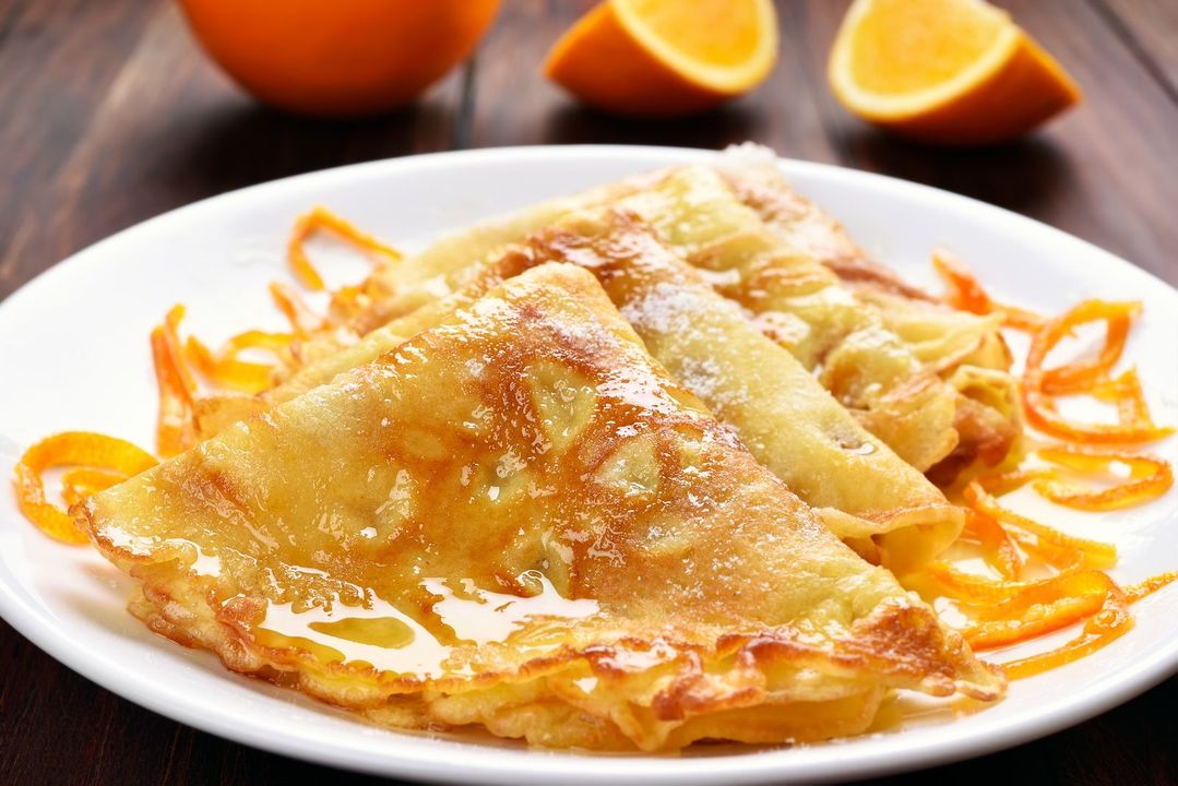 Crepes Suzette on white plate, close up view